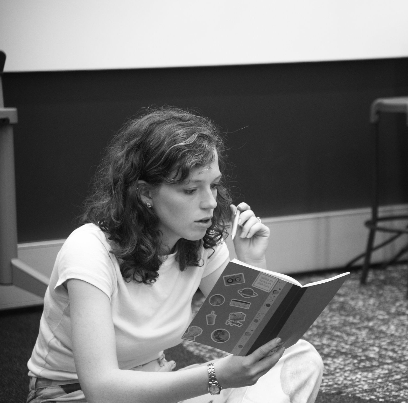 Rachael in rehearsals reading a notebook