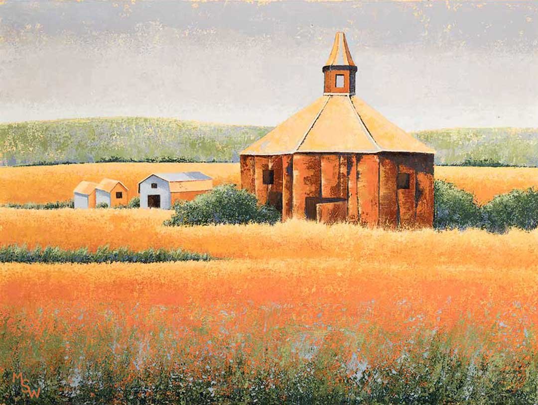 Original 24 × 18 acrylic painting of a round red-brown barn with a cupola, surrounded by golden and orange fields, small farm buildings, green shrubs, distant hills, and a pale textured sky.