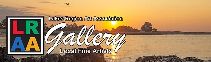 Logo of Lakes Region Art Association Gallery over a lakeside sunset with rocks in the foreground.