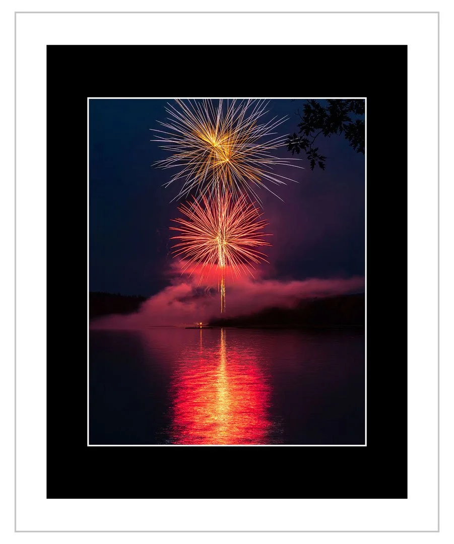 Fourth of July fireworks explode in a blaze of color over New Hampshire's Suncook Lake