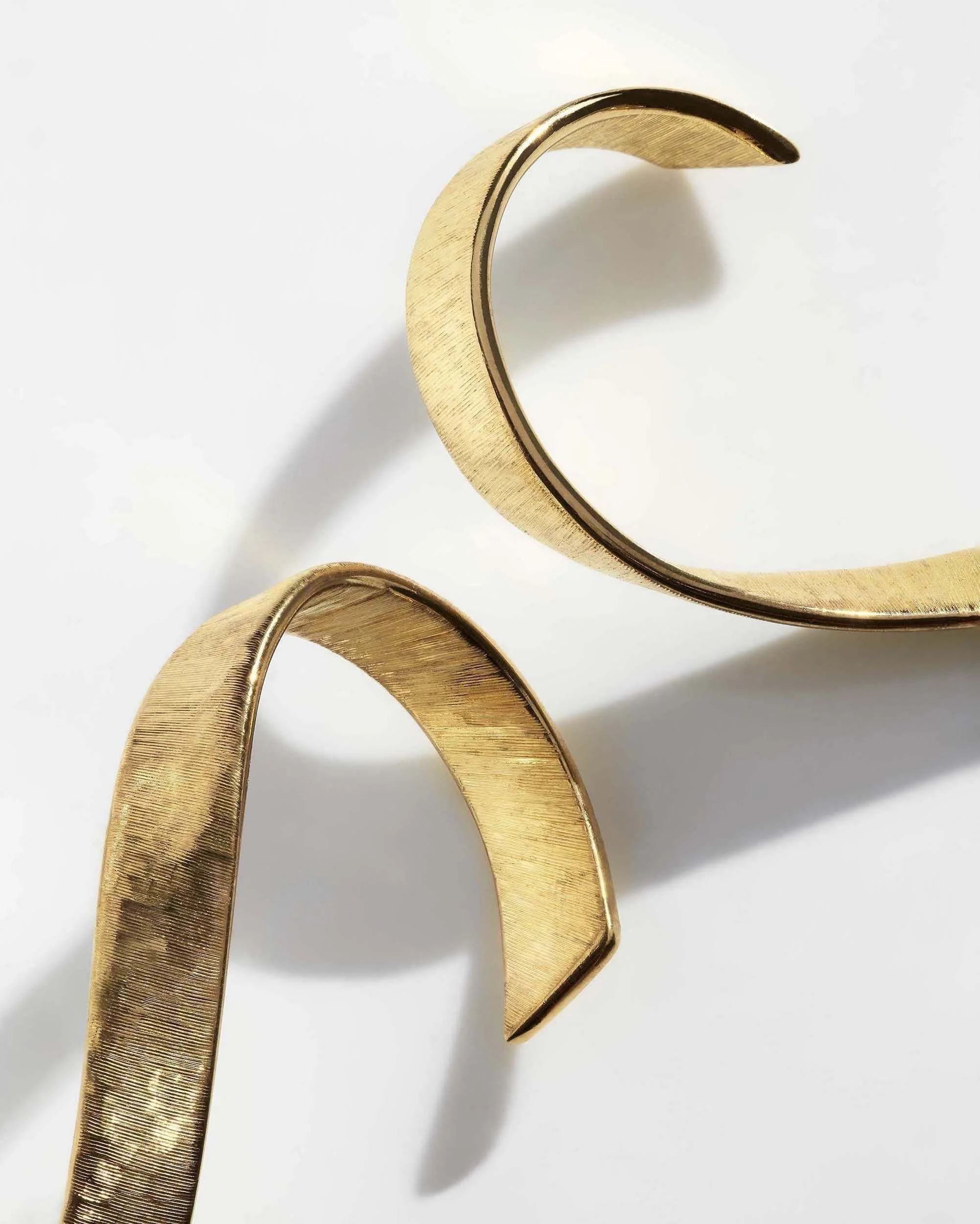Liv Luttrell Twist diamond hoop earrings. Yellow gold with natural warm-tone diamond edge, silk engraving.