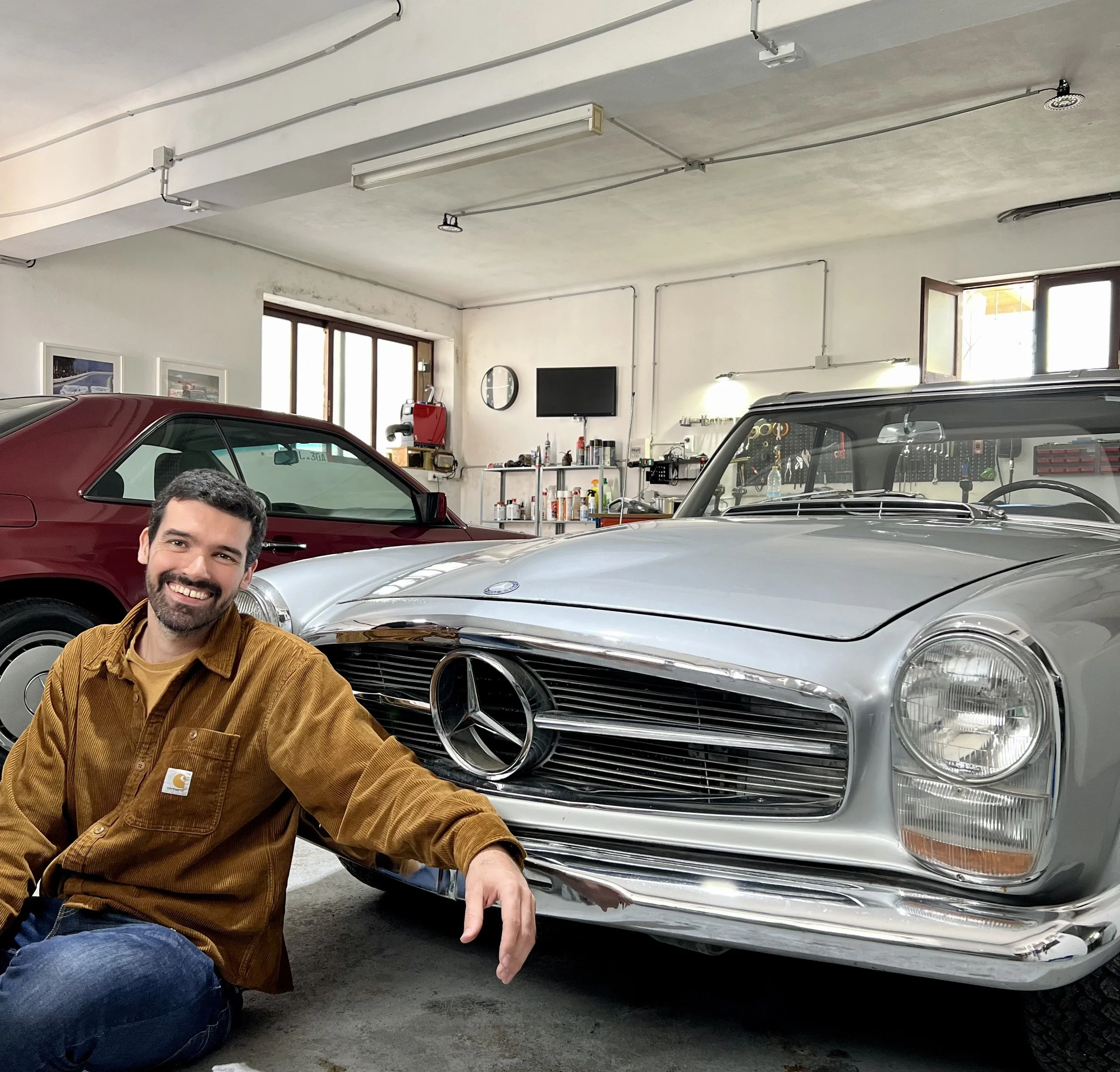 Cool and Classics owner sitting next to a Mercedes Pagoda