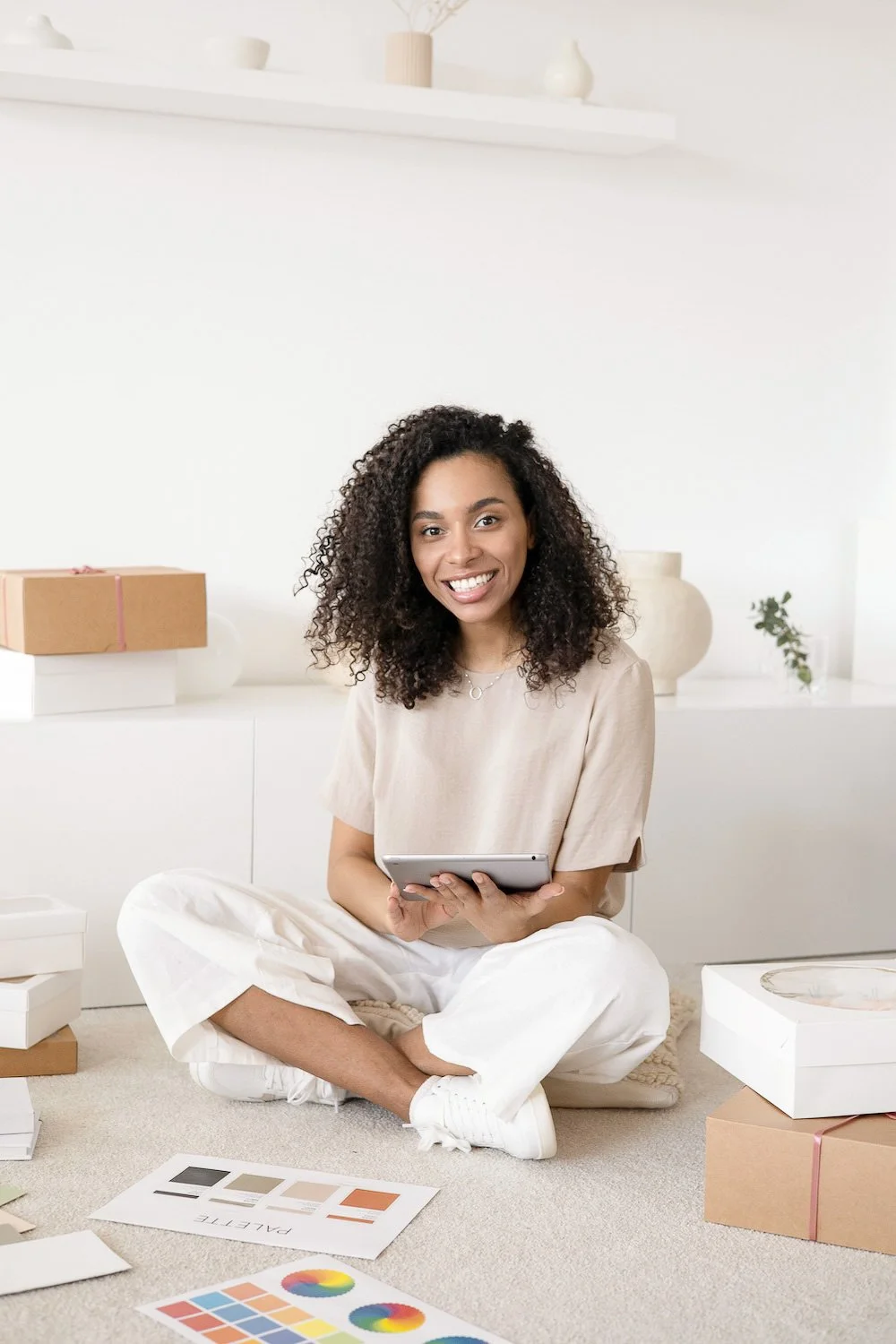 Photoshoot example: woman sat on floor with an iPad