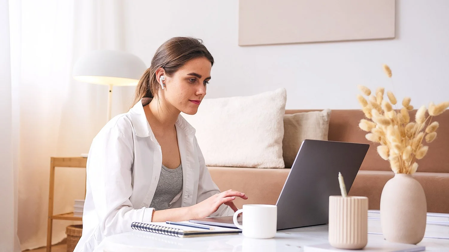Female small business owner, working on a laptop from home