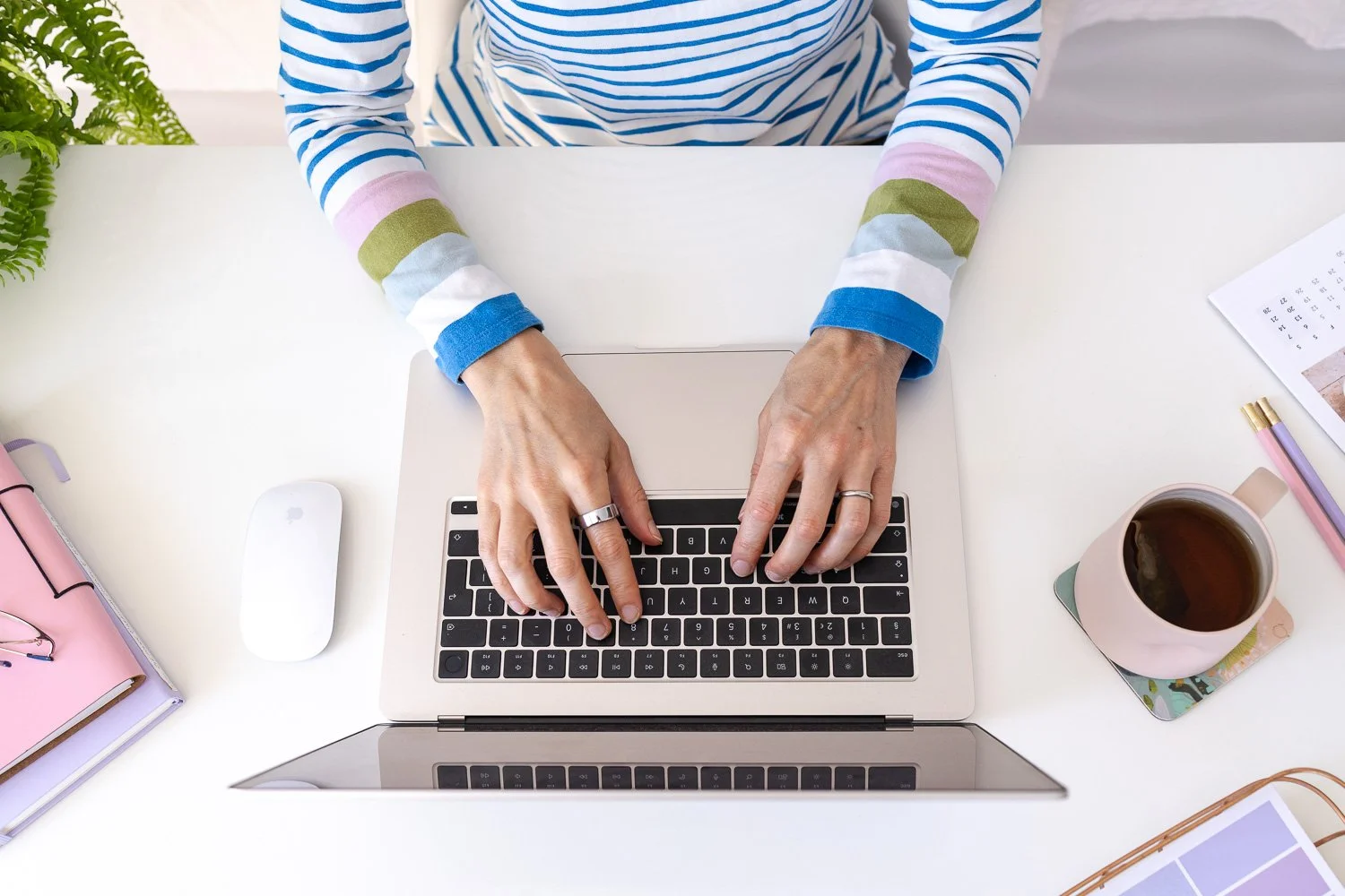 Zoe Power providing Squarespace support. Image shows her hands on the keyboard of her laptop