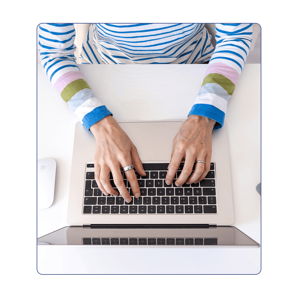 Zoe Power providing Squarespace support. Image shows her hands on the keyboard of her laptop