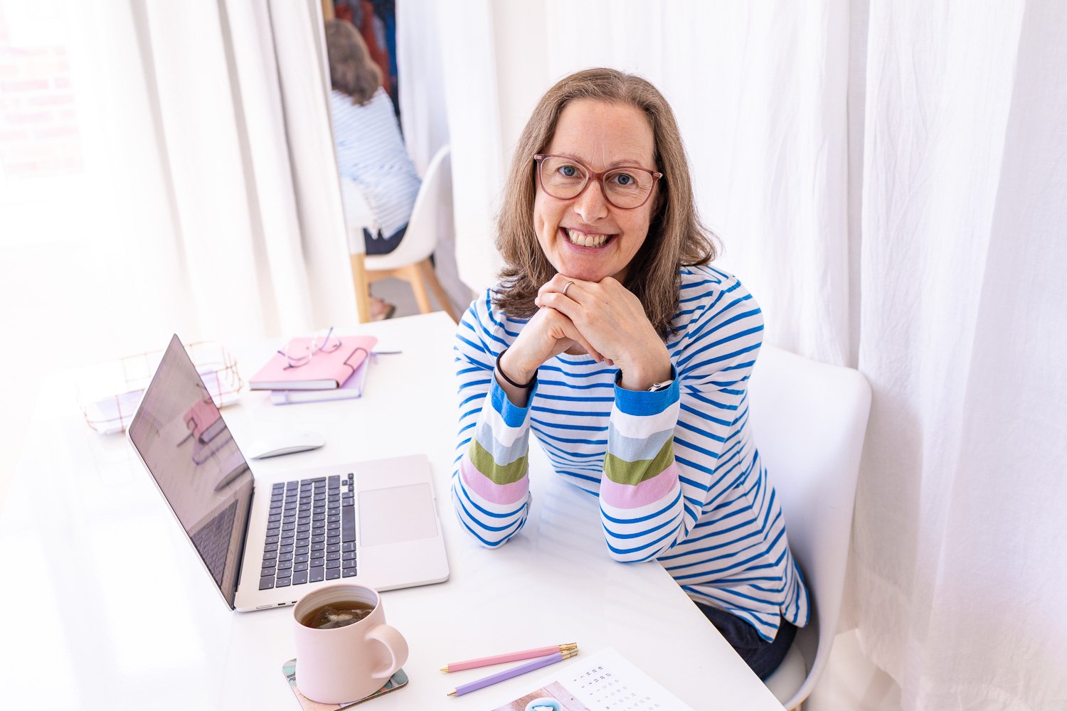 Zoe Power, Squarespace Web Designer UK, sat at her desk with laptop