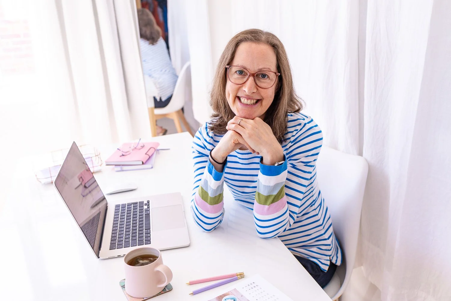 Example image of Zoe Power, Squarespace Web Designer, sat at her desk with laptop