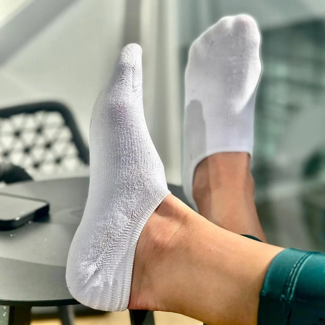 Comfortable Idegg no-show socks on feet, highlighting their fit and texture in a relaxed pose.