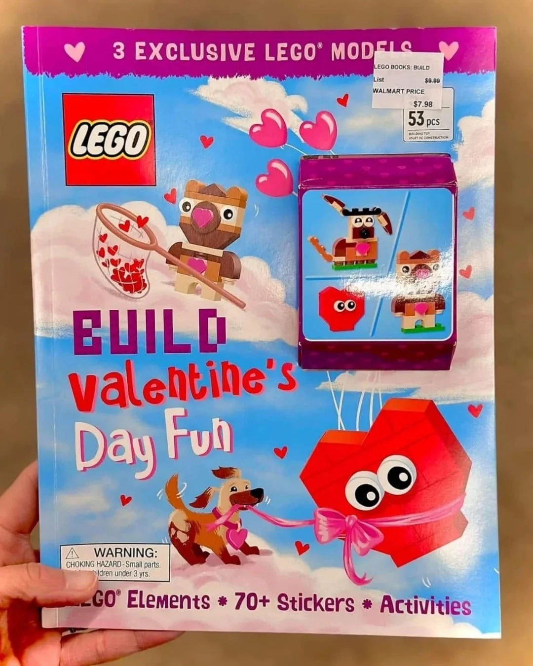 LEGO Build Valentine's Day Fun kit cover showing heart-shaped balloons, a brown LEGO creature, and a red heart with googly eyes, designed for kids' holiday fun.