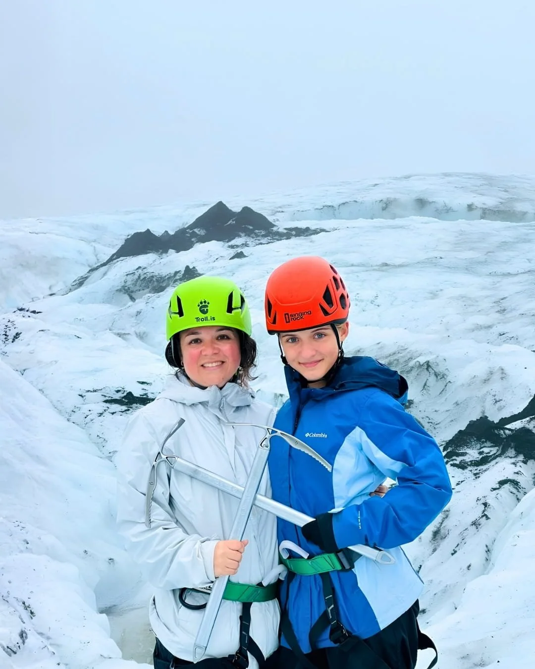 Nicole wearing THE NORTH FACE women’s waterproof jacket and climbing gear on a glacier