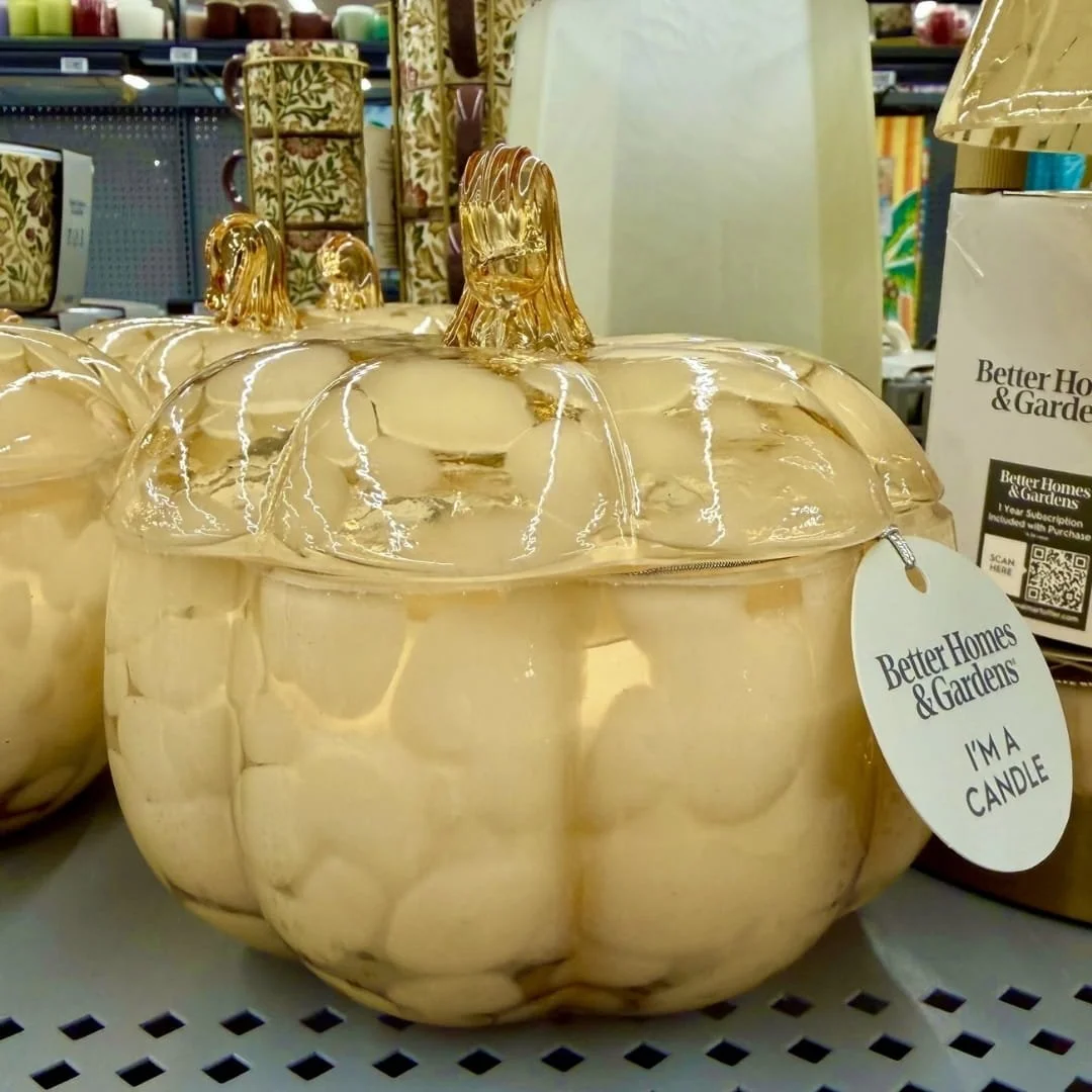 mber glass pumpkin jar candle on a retail shelf with Better Homes and Gardens branding for fall home decor