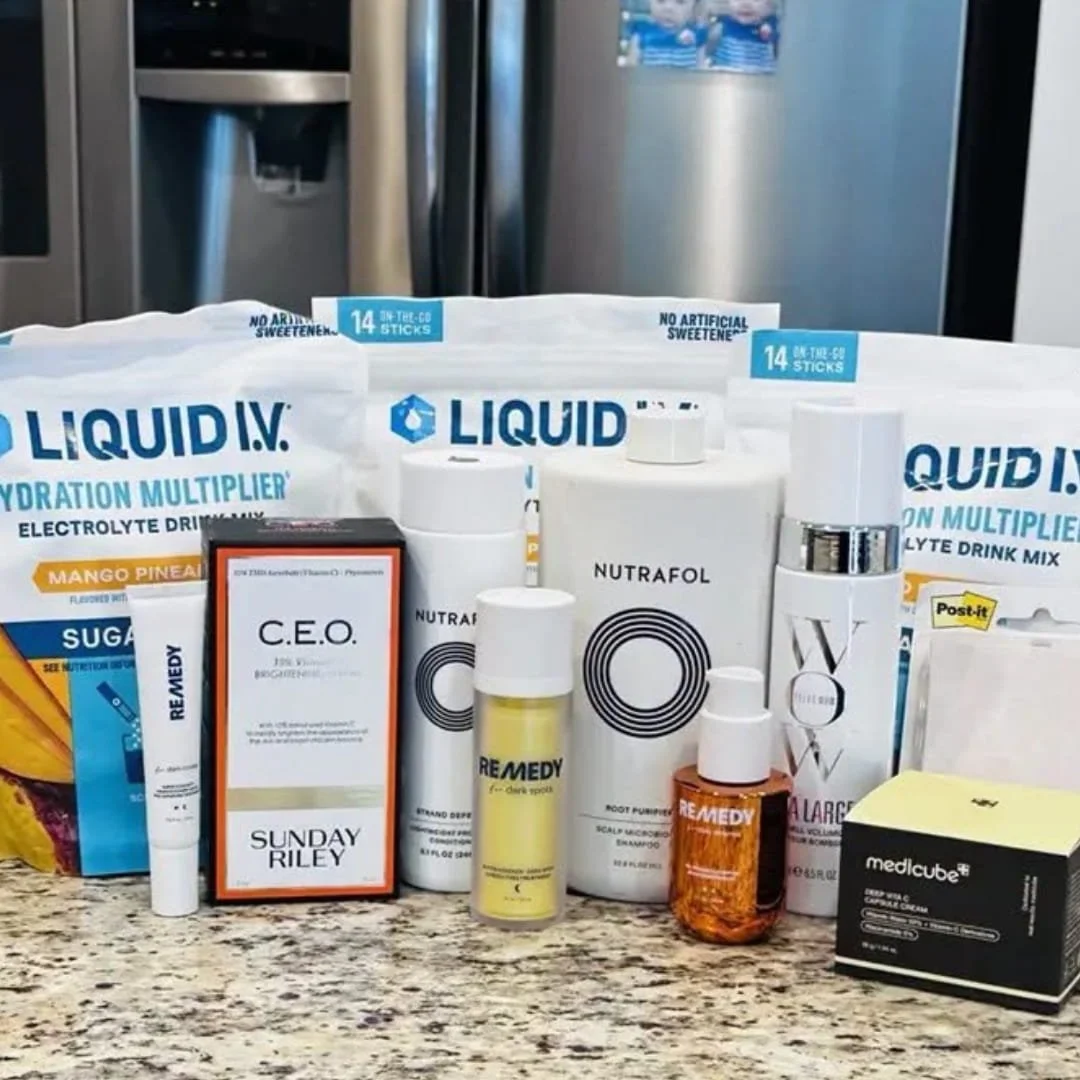 Assorted Prime Day finds including hydration mixes, haircare, skincare, and wellness products arranged on a kitchen countertop