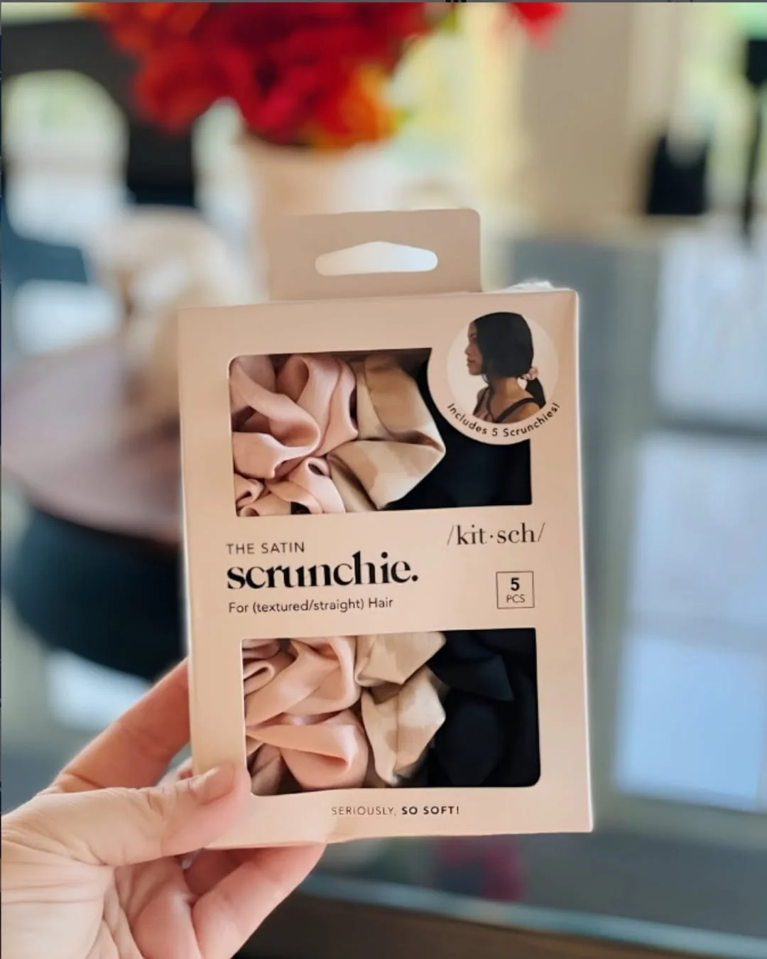 Pack of Kitsch satin scrunchies in pink, champagne, and black displayed in retail packaging