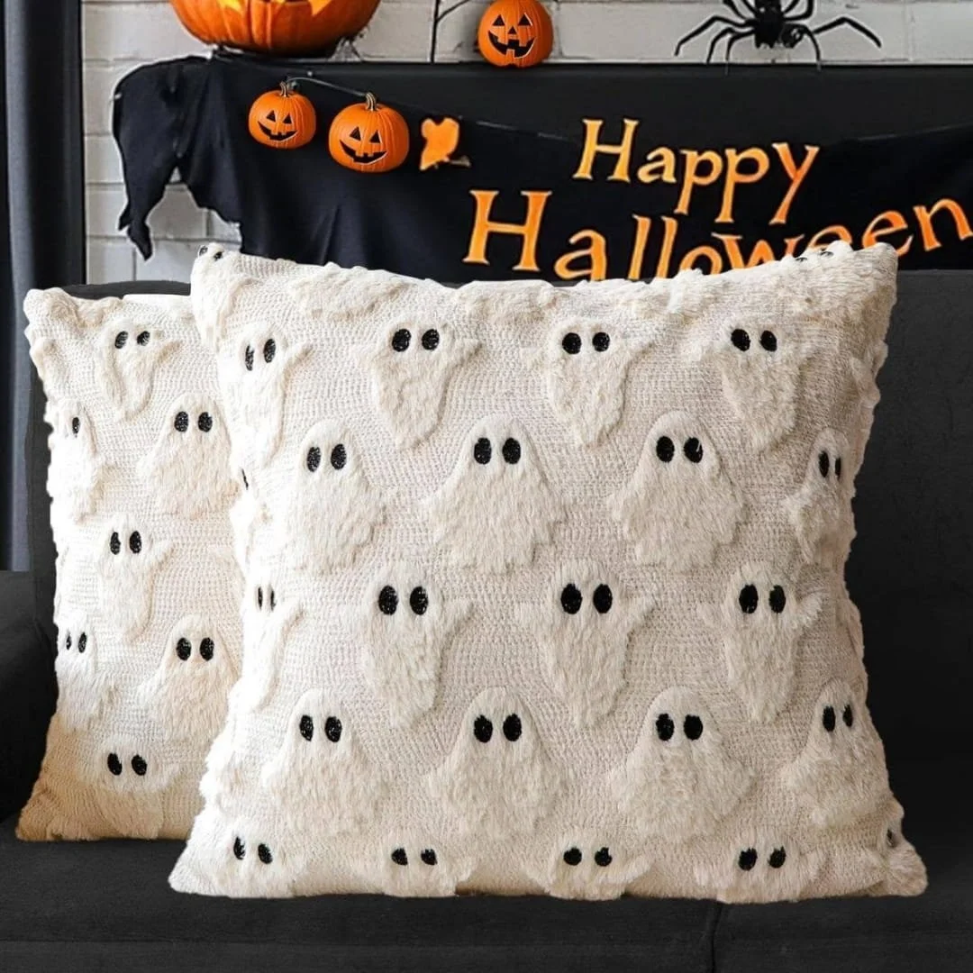 Cream Halloween pillow covers with tufted ghost patterns displayed on a dark couch with festive pumpkins and a Happy Halloween banner