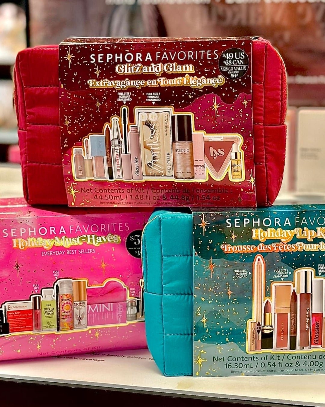 Sephora Favorites holiday gift sets featuring Glitz and Glam, Holiday Must-Haves, and Holiday Lip Kit, each with a festive quilted cosmetic bag and popular beauty products from brands like ILIA, Glossier, Charlotte Tilbury, and Rare Beauty.