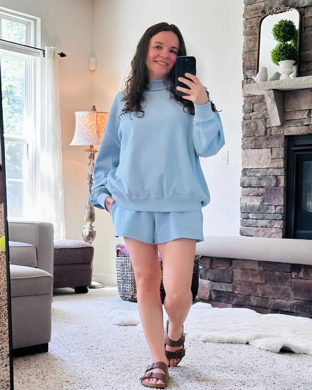 Nicole wearing a light blue Aerie mockneck sweatshirt with matching shorts in a mirror selfie