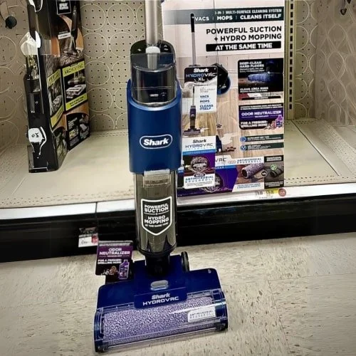 Shark HydroVac XL cleaner on retail display, featuring vacuum, mop, self-cleaning, and odor neutralizer.