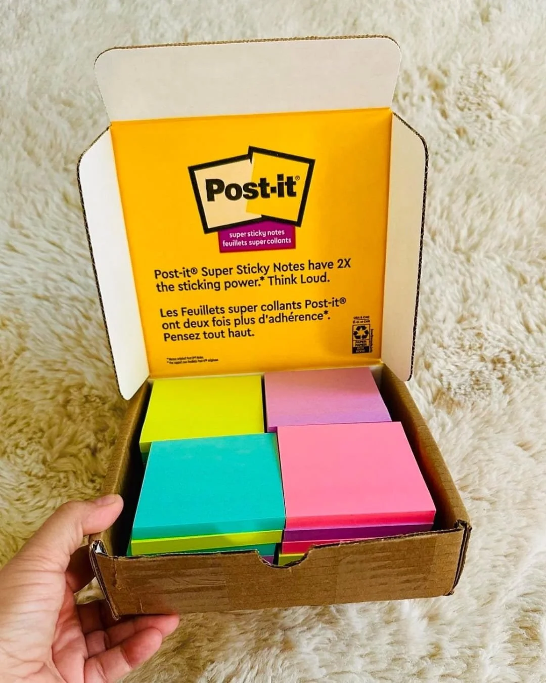 Open box of Post-it Super Sticky Notes in assorted bright colors