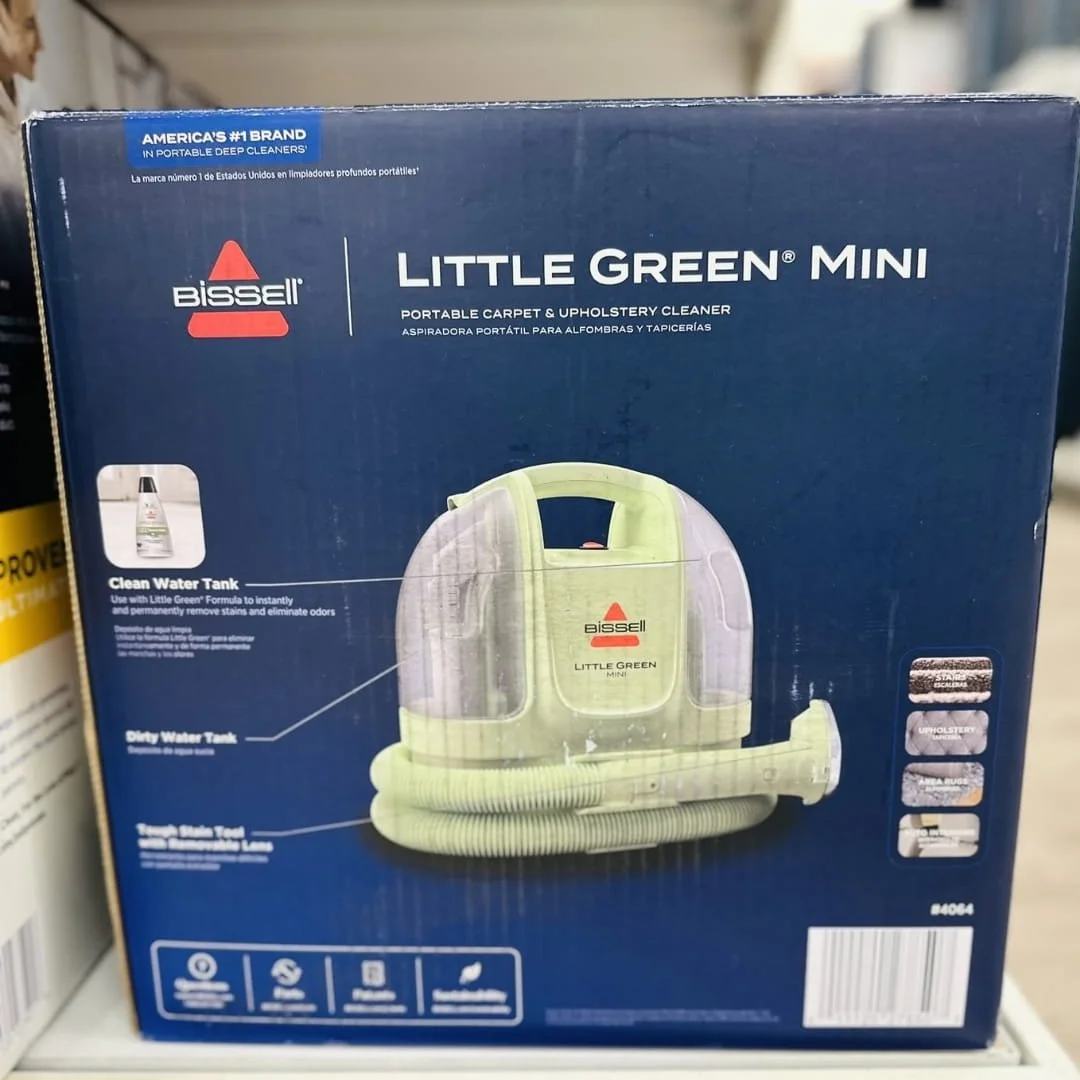 Front of the BISSELL Little Green Mini portable deep cleaner box showing the compact carpet and upholstery cleaner, product features, and cleaning uses for stairs, upholstery, rugs, and car interiors