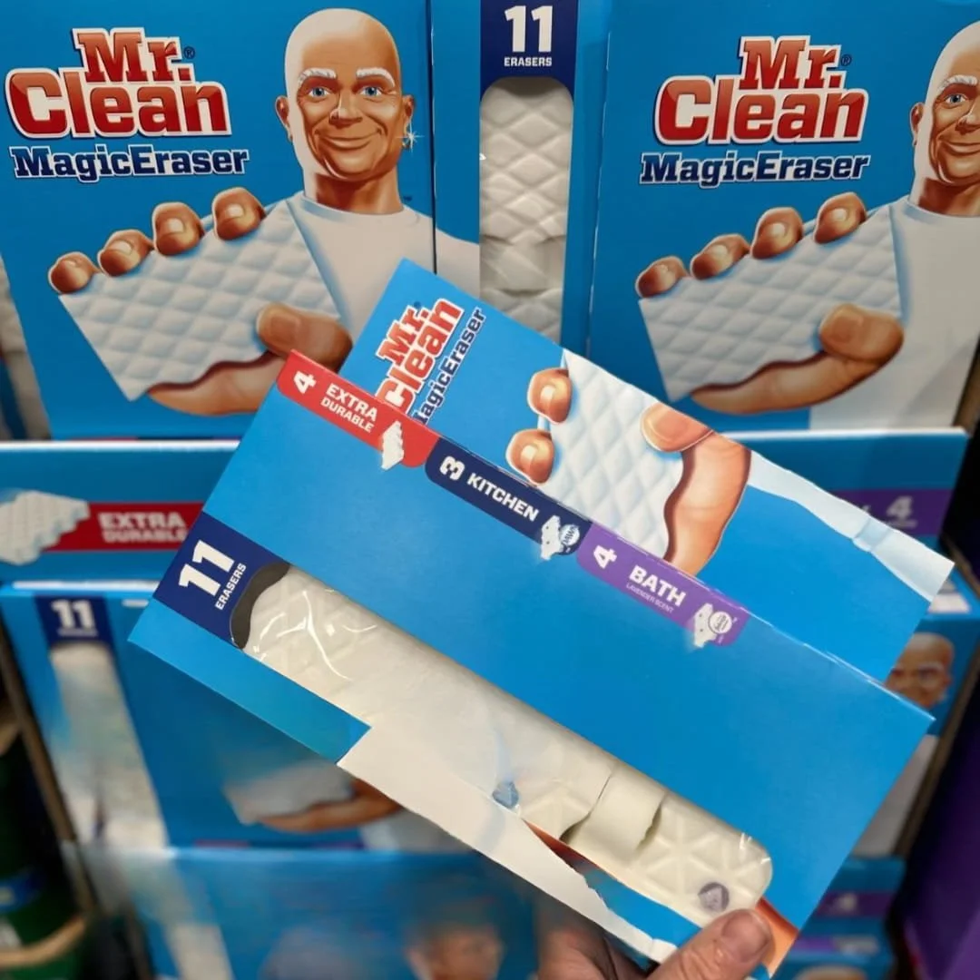 Mr. Clean Magic Eraser variety pack with 11 sponges, including Extra Durable, Kitchen, and Bath Lavender Scent erasers, displayed in blue packaging with a hand holding an open box revealing the sponges.