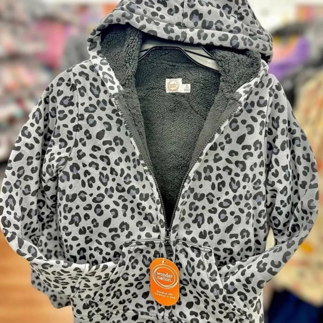 Leopard print zip-up hoodie jacket with a cozy sherpa lining, featuring a stylish design and eco-conscious branding by Wonder Nation. Perfect for keeping warm and fashionable during cooler seasons.