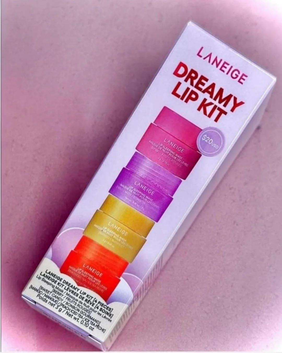LANEIGE 4-piece lip sleeping mask set in vibrant pink, purple, yellow, and orange containers, packaged in a sleek white box with product details and price sticker.