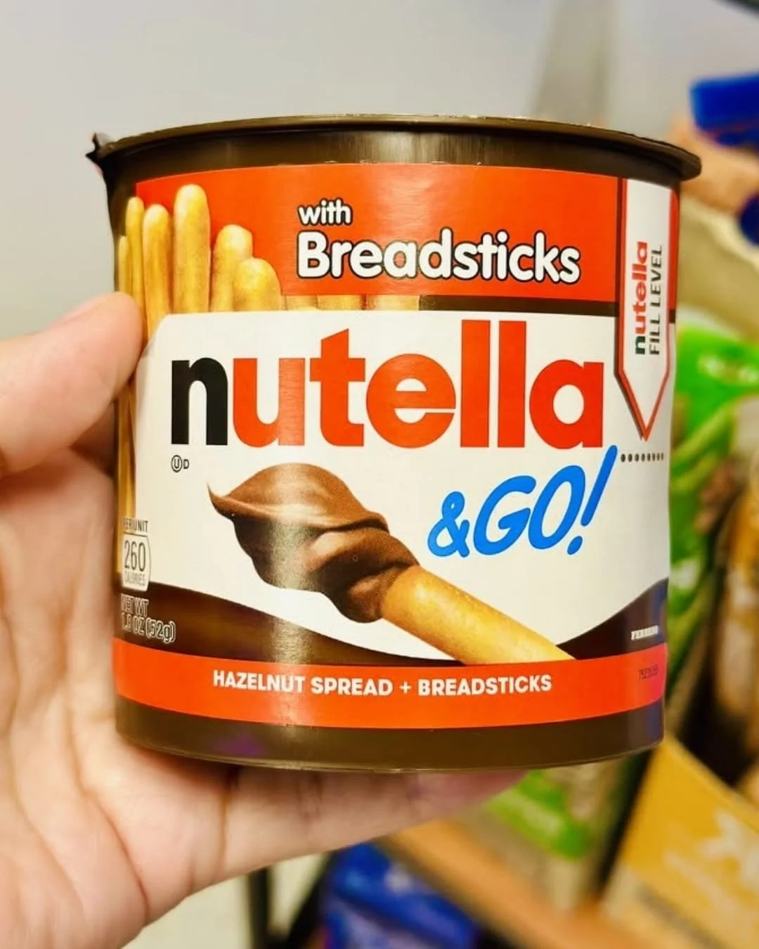 Nutella and GO breadsticks snack pack with hazelnut spread and breadsticks held in hand