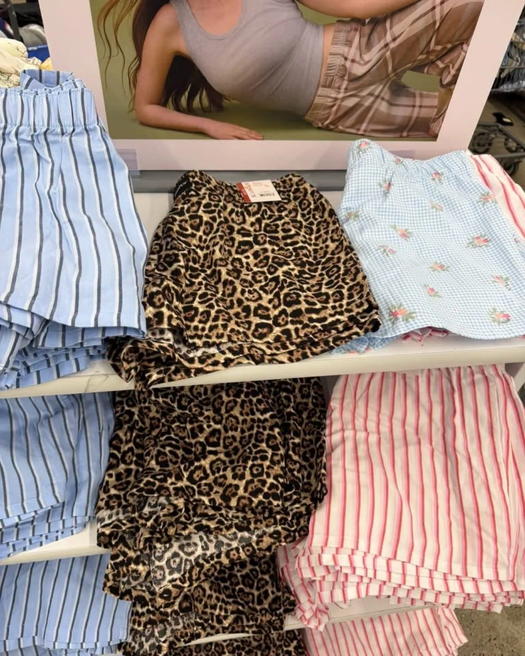 Retail display of women’s boxer shorts in striped, leopard, and floral patterns stacked on store shelves