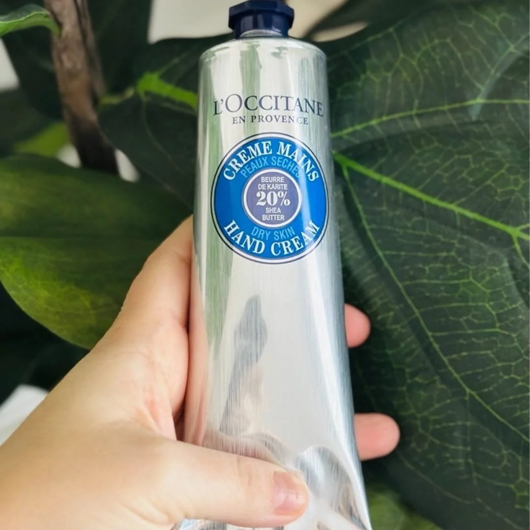 L'Occitane Shea Butter Hand Cream with 20% Shea Butter, designed for dry skin. Packaged in a sleek silver tube, it provides intense hydration and nourishment for soft, smooth hands.