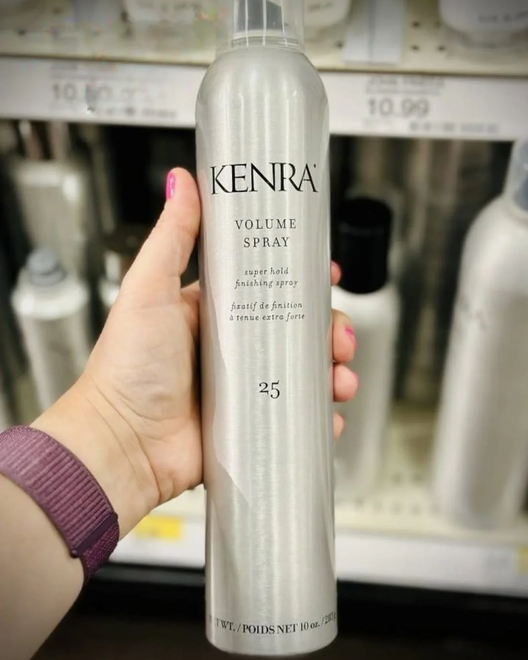 Kenra Volume Styling Spray 25 aerosol can held in hand in beauty store aisle