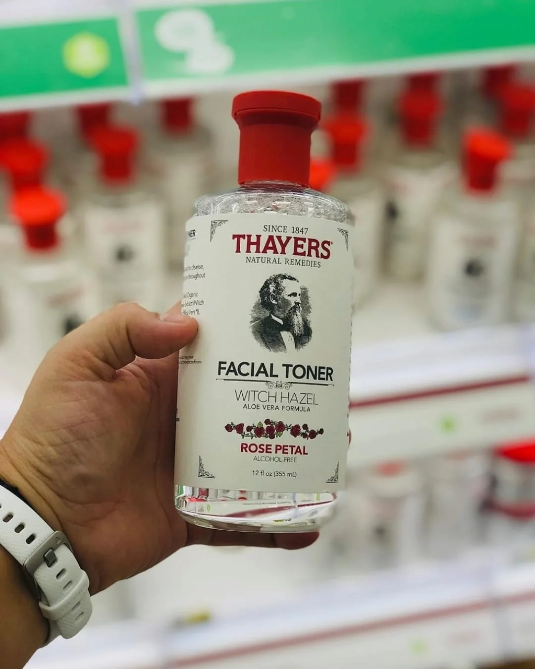THAYERS Rose Petal Facial Toner bottle held in hand in store aisle