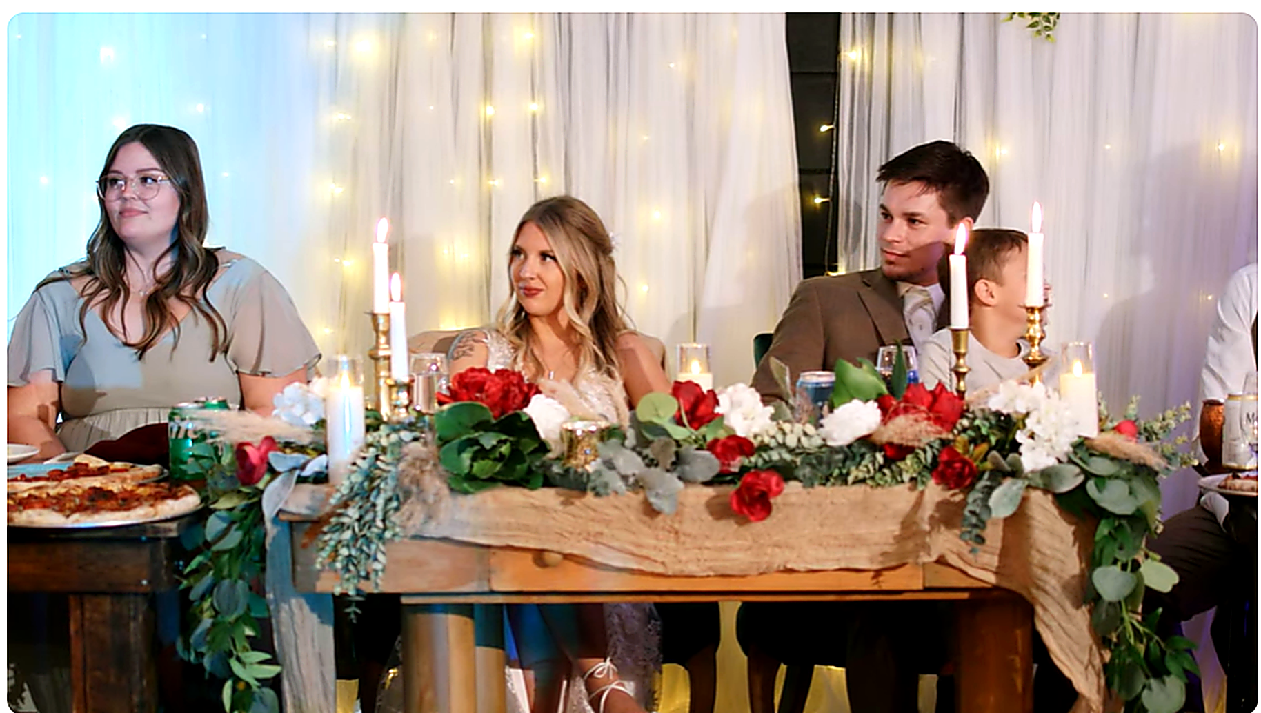 Wedding reception sweetheart table with floral centerpiece