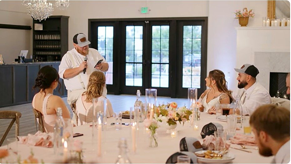 Wedding guest giving a toast during reception dinner at LedgeCrest Reserve, with bride and groom seated at the head table