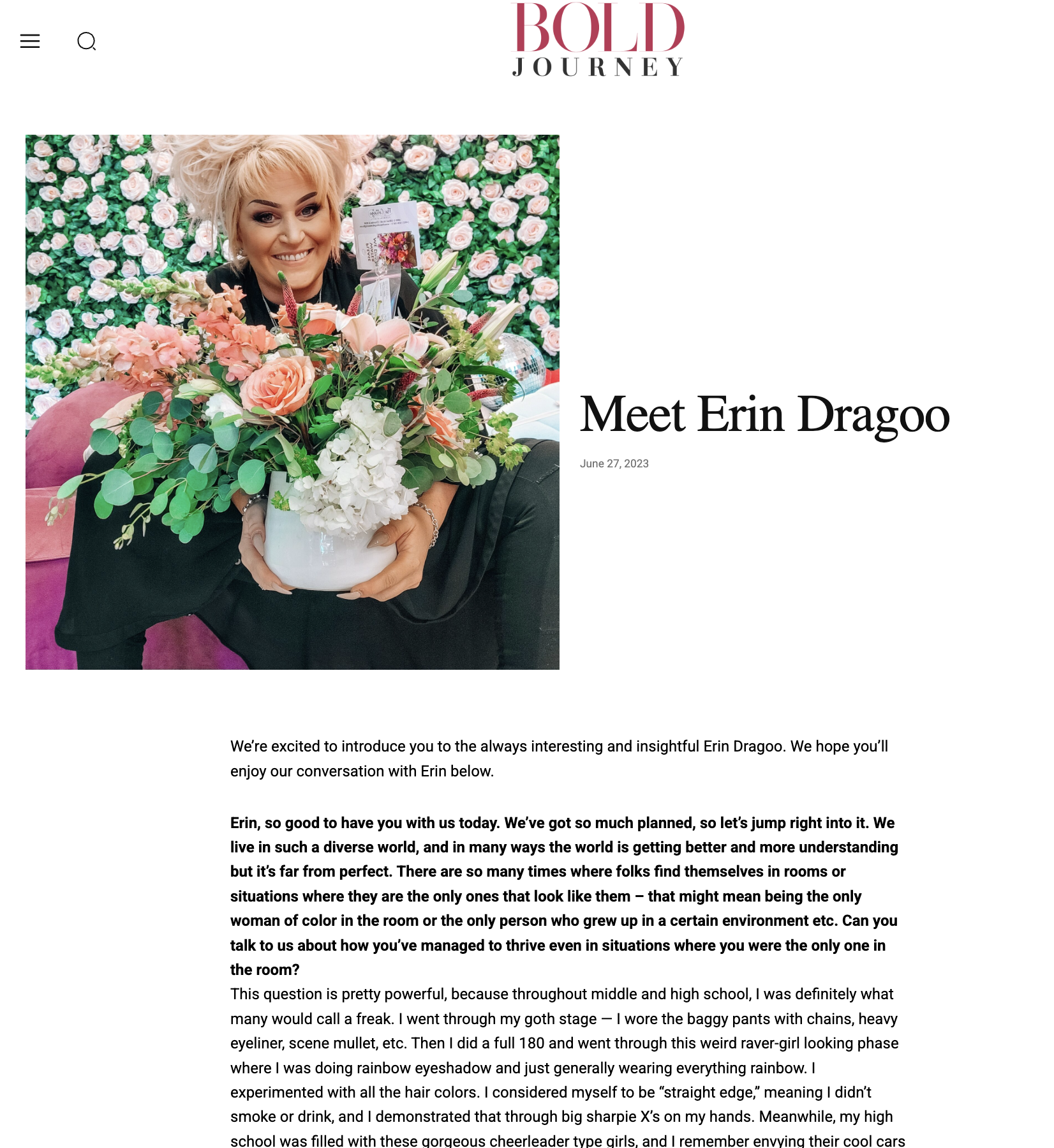 A woman with blonde hair holding a large bouquet of pink and white flowers in front of a pink and green floral backdrop.
