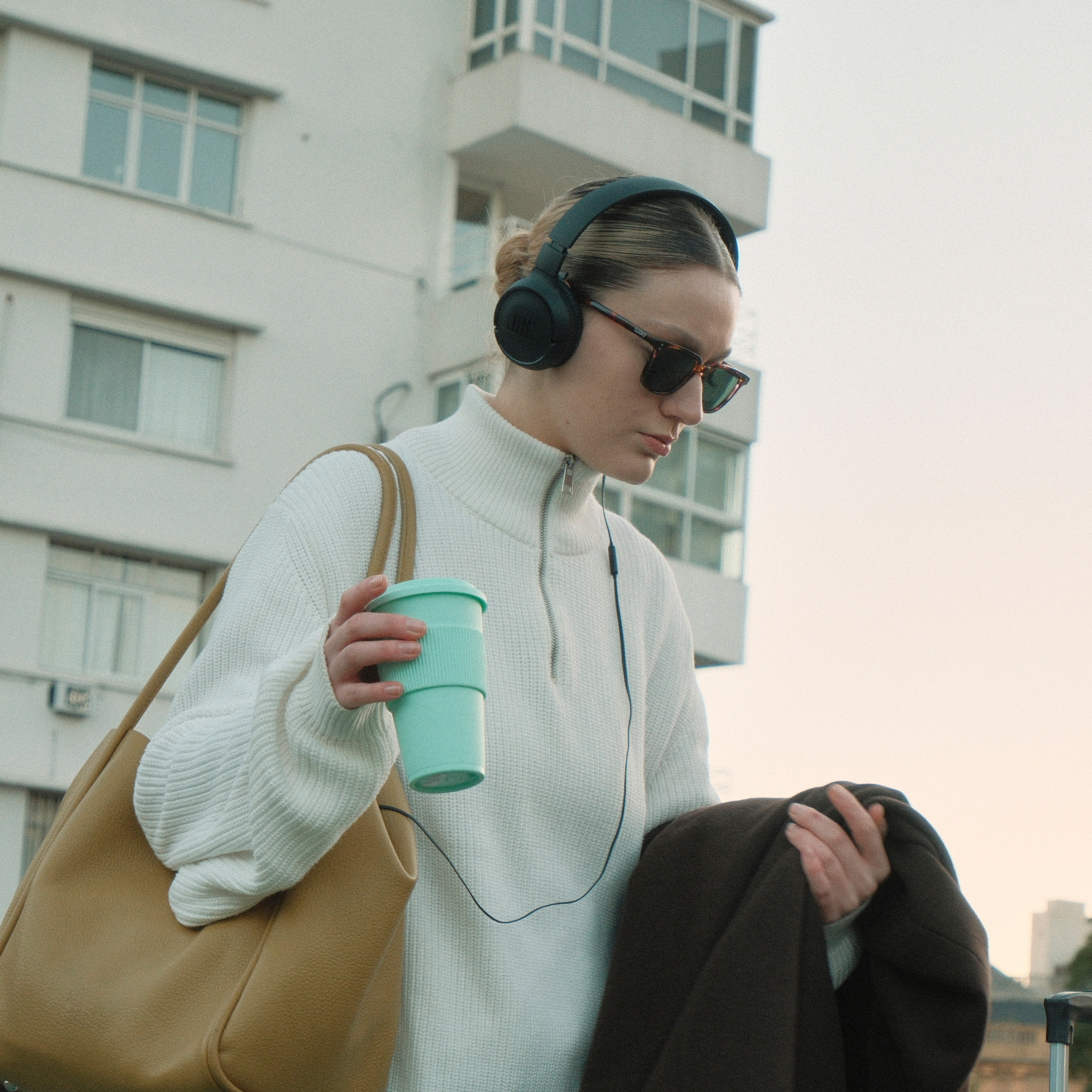 White woman professional walking with headphones