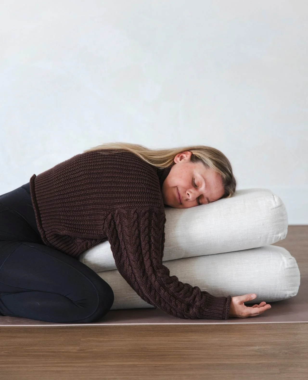 Thinking about trying Restorative Yoga? We highly recommend. 🤍⁠
⁠
Rest doesn't always come easily. Restorative creates the conditions for it. Supported by bolsters, blankets, blocks, and other props, the body is invited to soften into long-held, pas