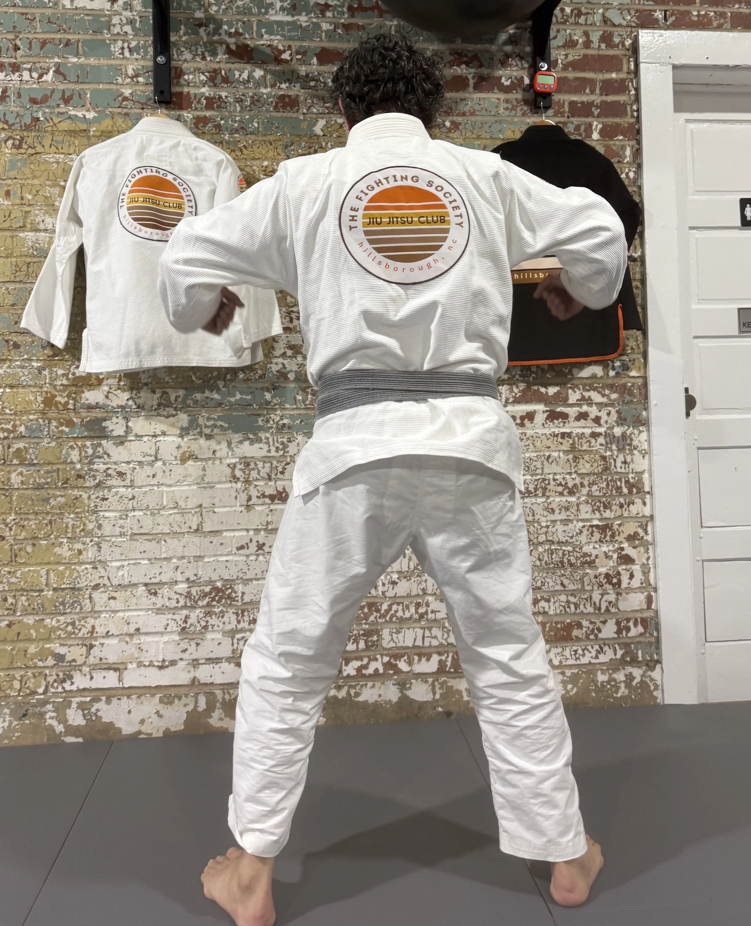 The Fighting Society Gi - Orange ROUND LOGO
