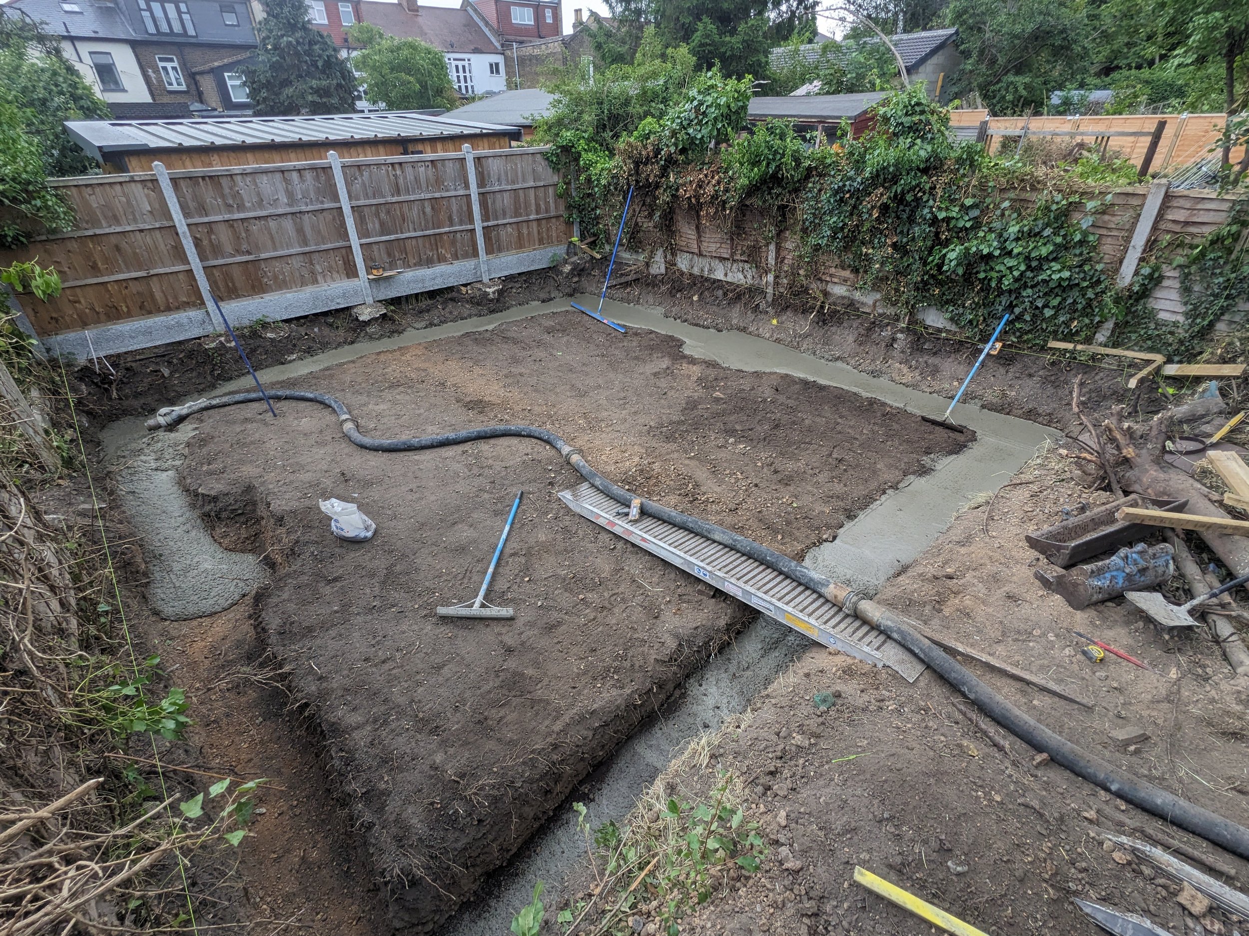 foundations being poured for yoga studio in east london garden