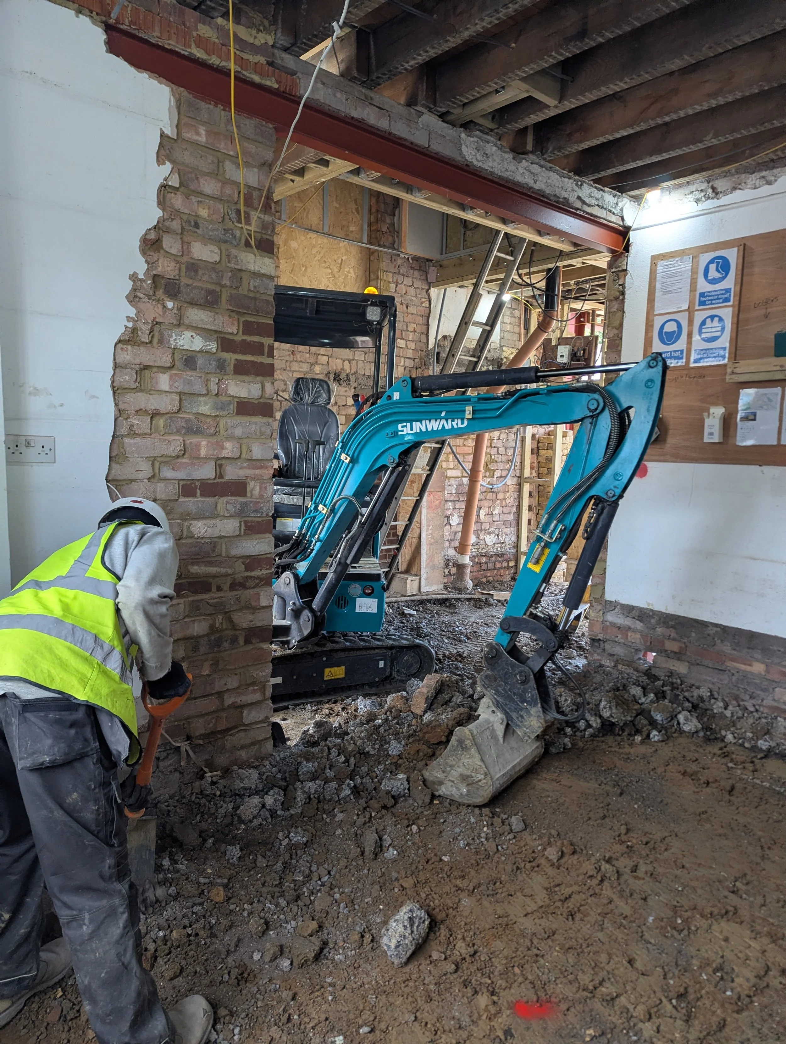 finchley extension mini digger excavating inside building