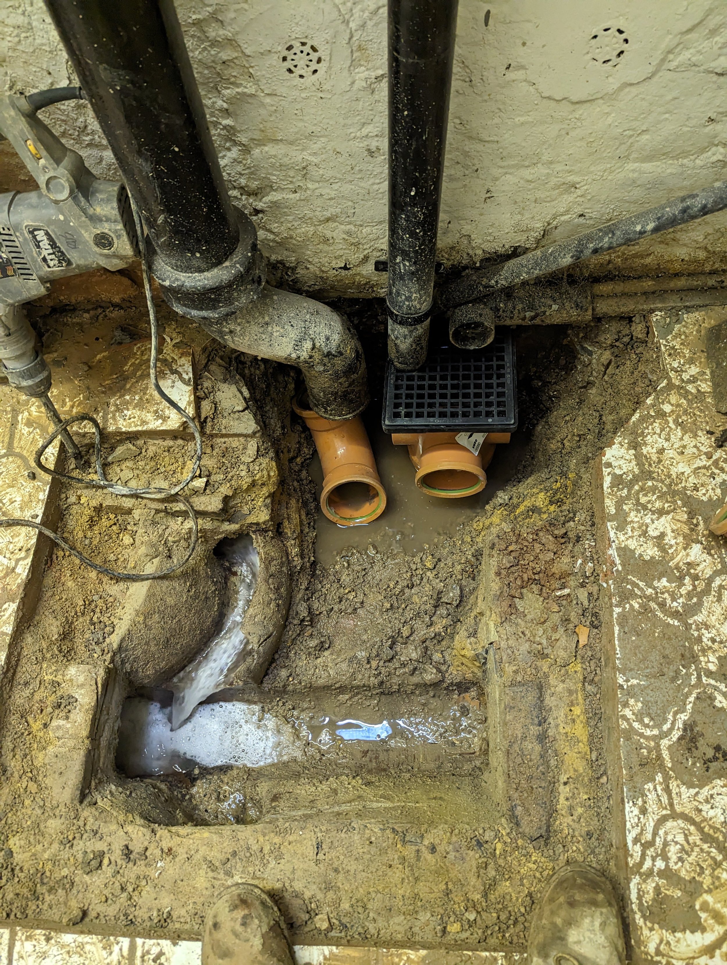 manhole partially removed to repair damaged pipework in basement in marylebone