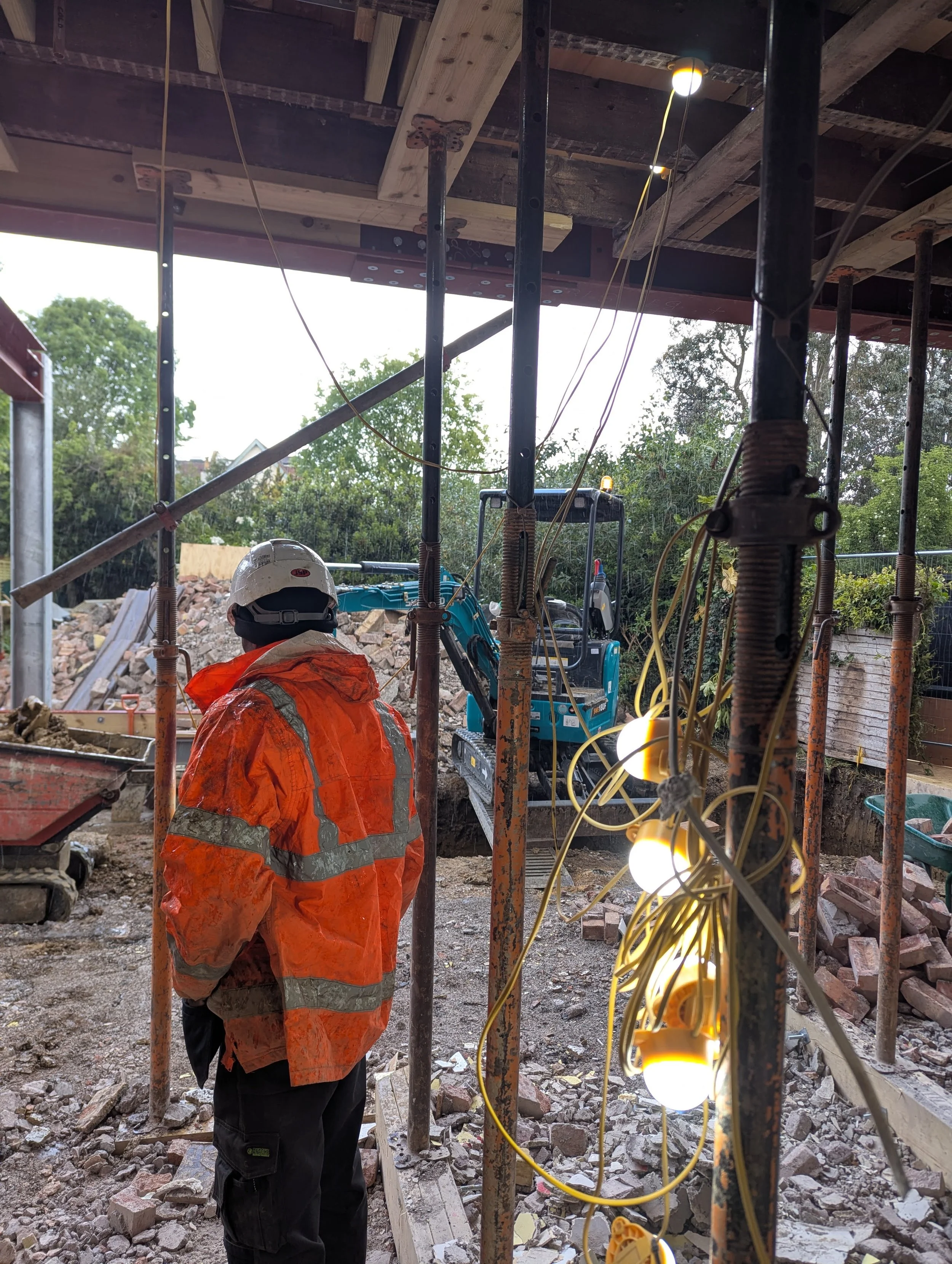 finchley extension groundworker standing amongst props with machines in background