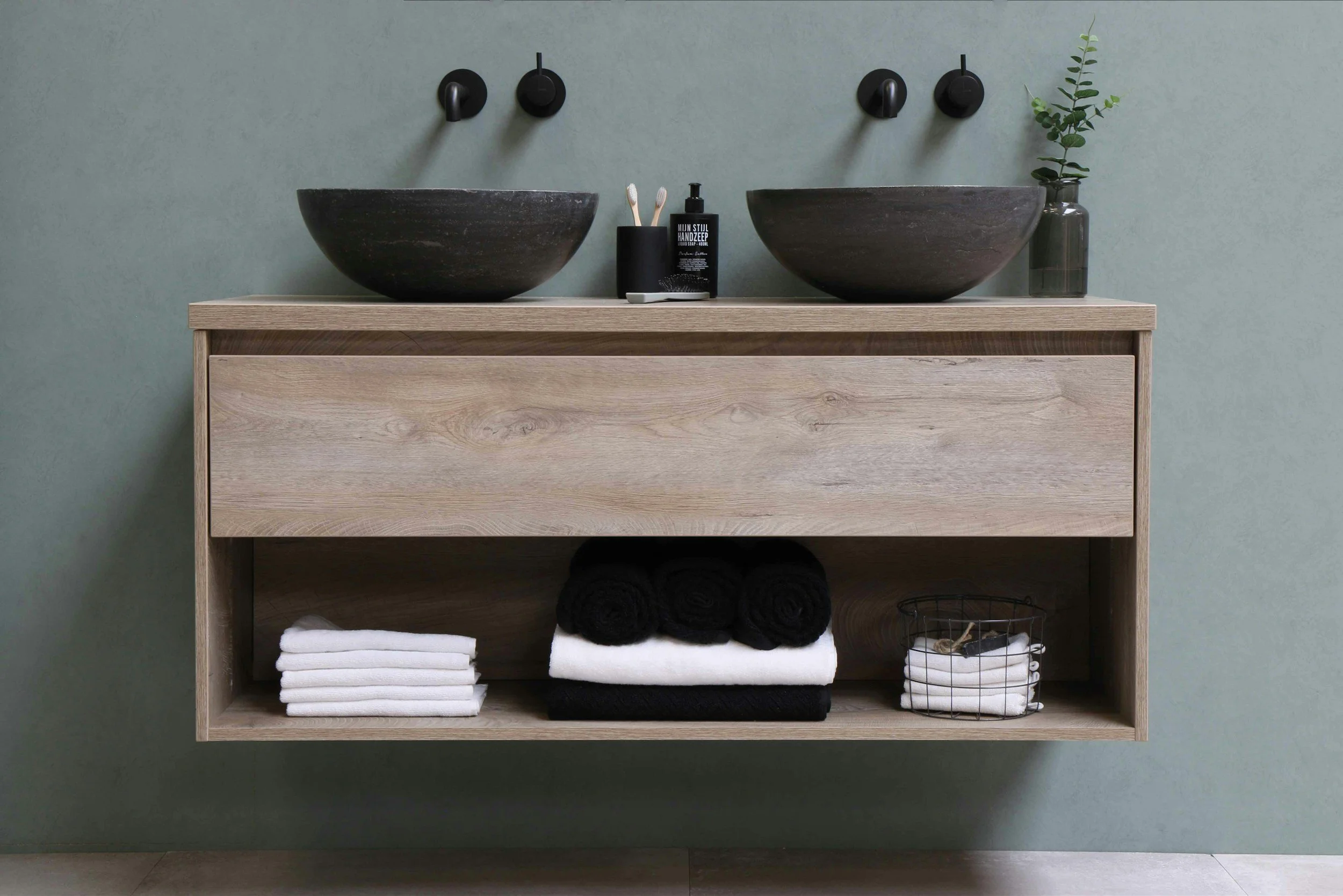 Cover photo on the bathroom renovations page featuring a floating wood bathroom vanity with a vessel sink for a modern, airy feel.