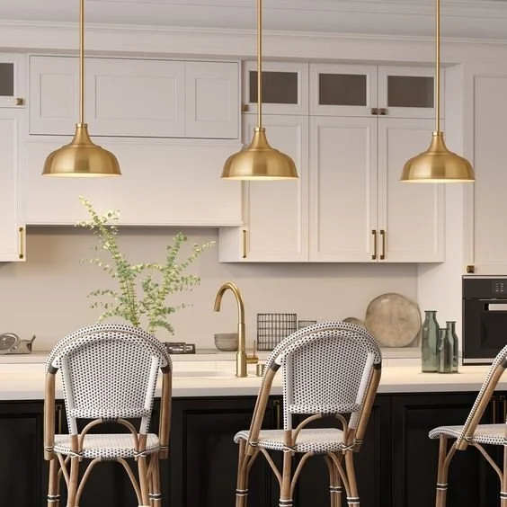 Brass pendant lighting installation over remodeled kitchen island