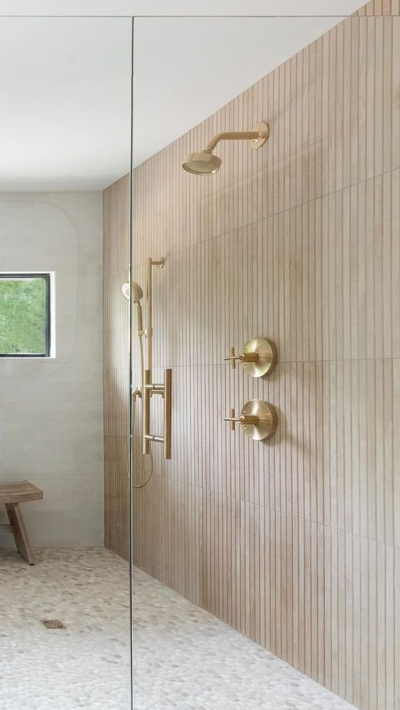 Showers, highlighting a full glass-enclosed tile shower with gold fixtures for a luxurious and open design.