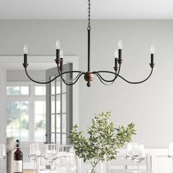 Farmhouse chandelier lighting installation over kitchen table