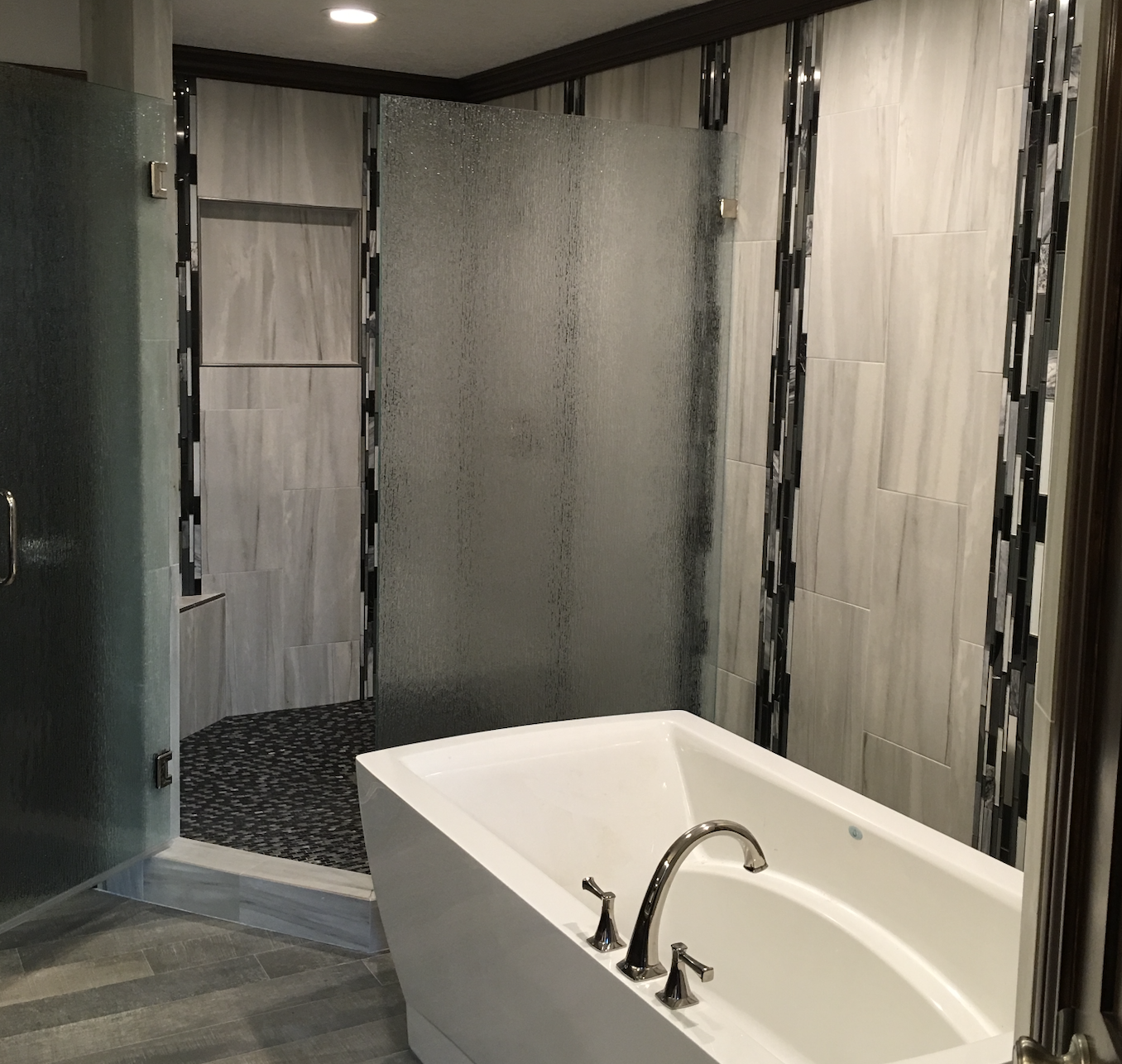 traditional bathroom remodel with custom shower tile work and stand alone tub