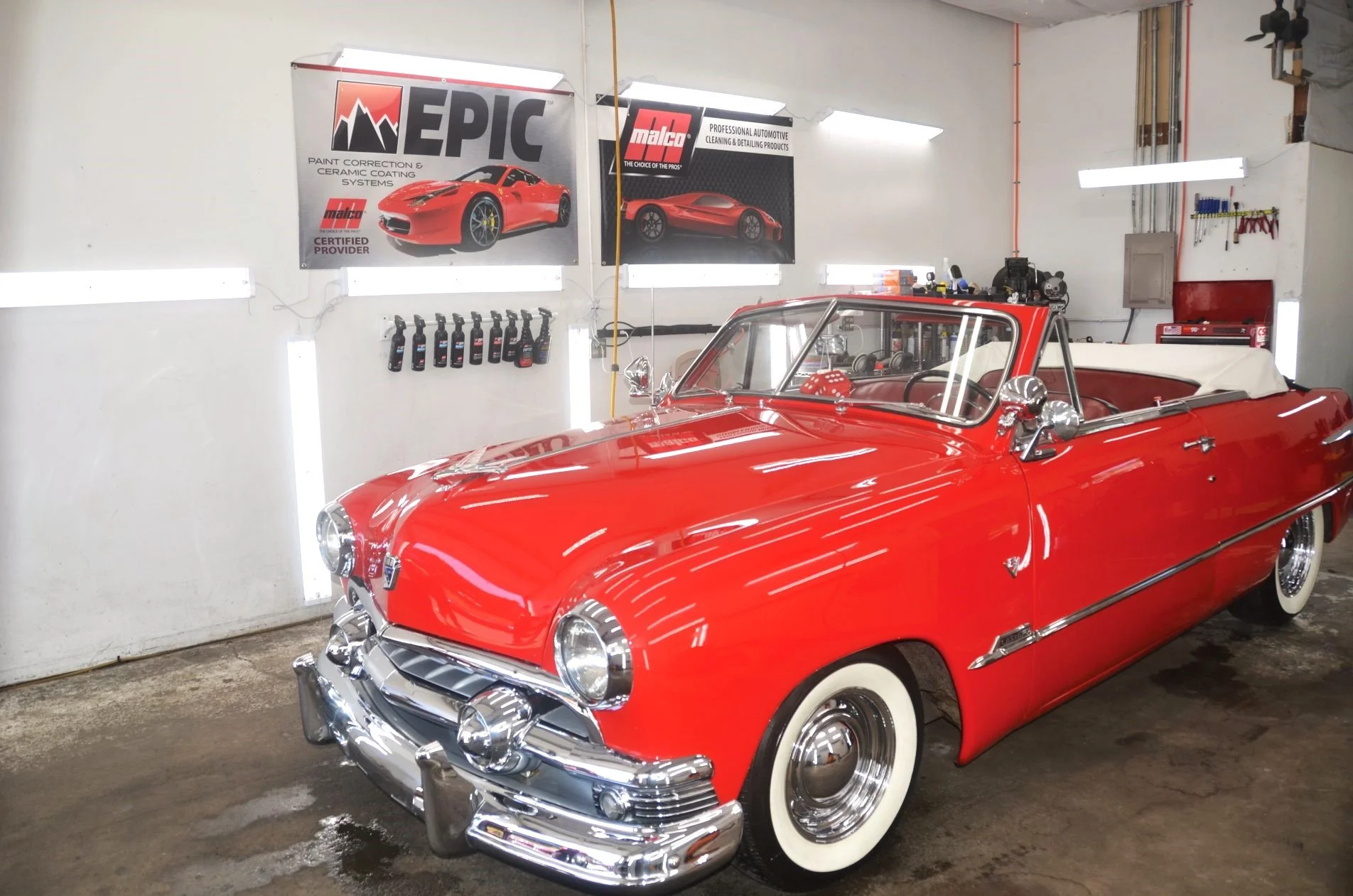 Freshly detailed classic red convertible inside the Coastline Auto Detail shop in Lincoln City, Oregon