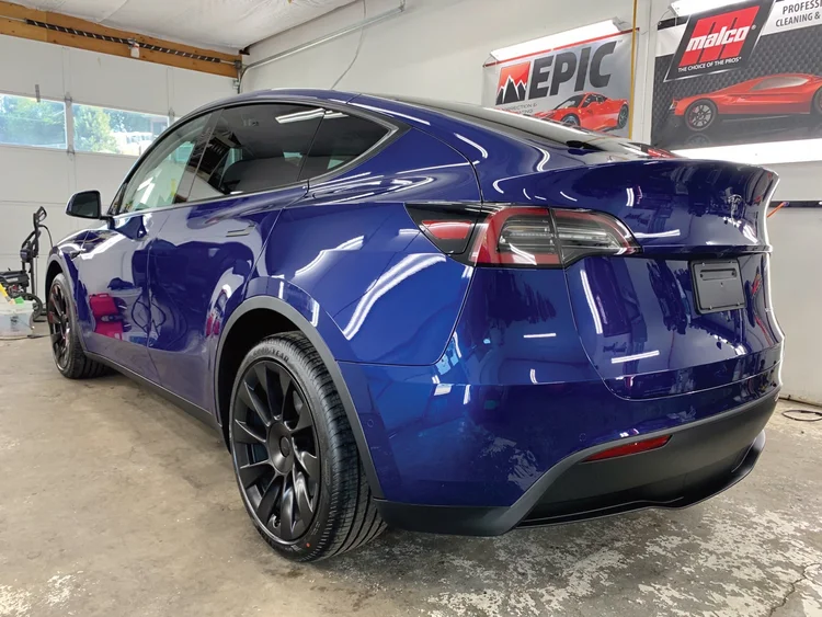 Blue Tesla Model Y with a deep gloss finish