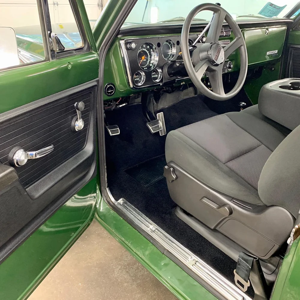 Clean interior of a restored green pickup after an interior detail